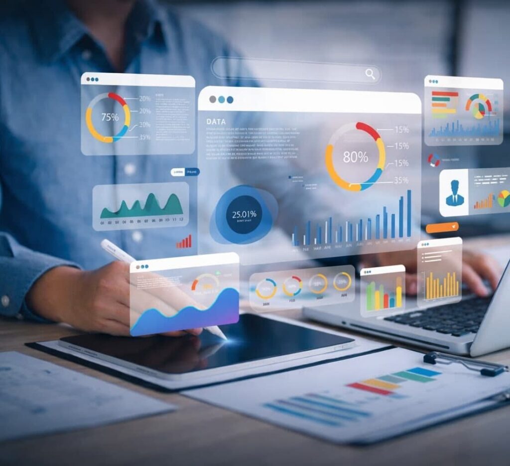 Person analyzing digital data dashboards and charts on a laptop and tablet.